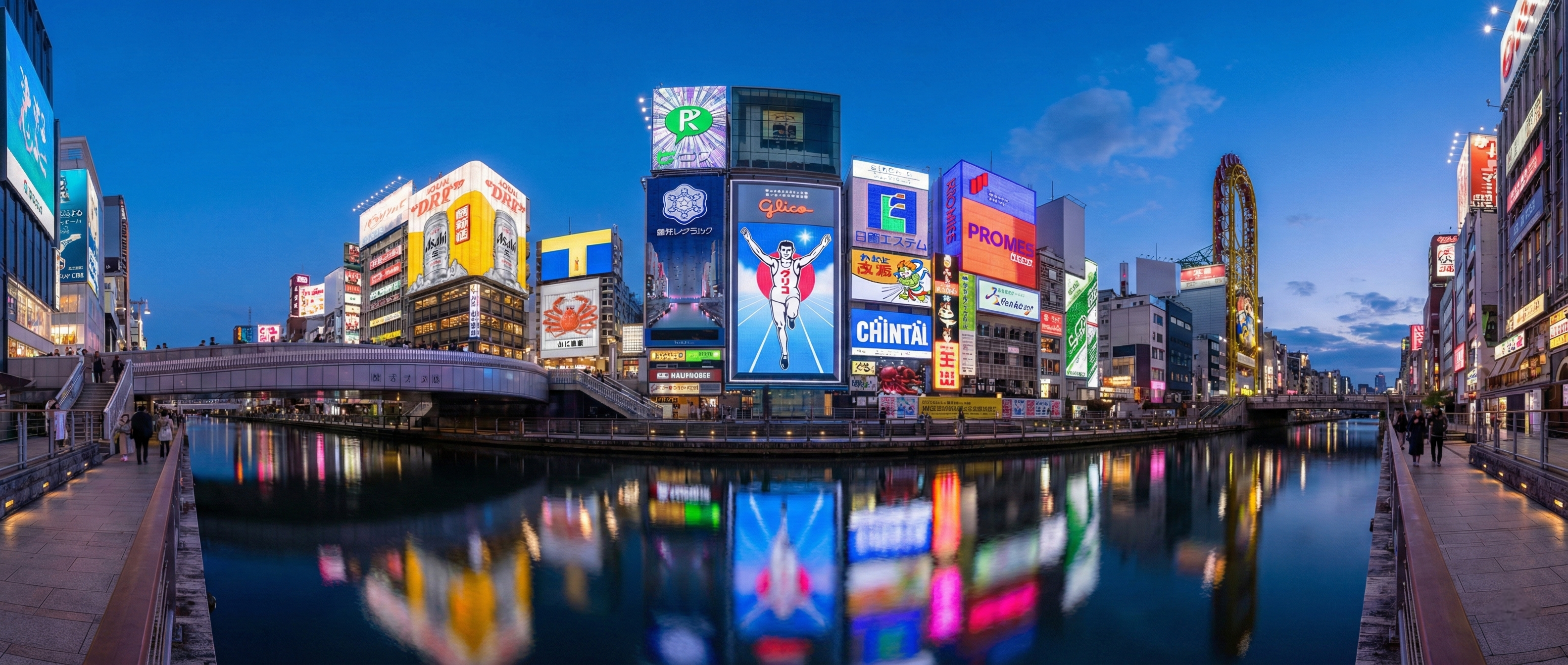 A wide panoramic view of the Dotonbori canal at dusk, showing the perfectly still water reflecting vibrant neon billboards and digital signs in shimmering, vertical lines of light.