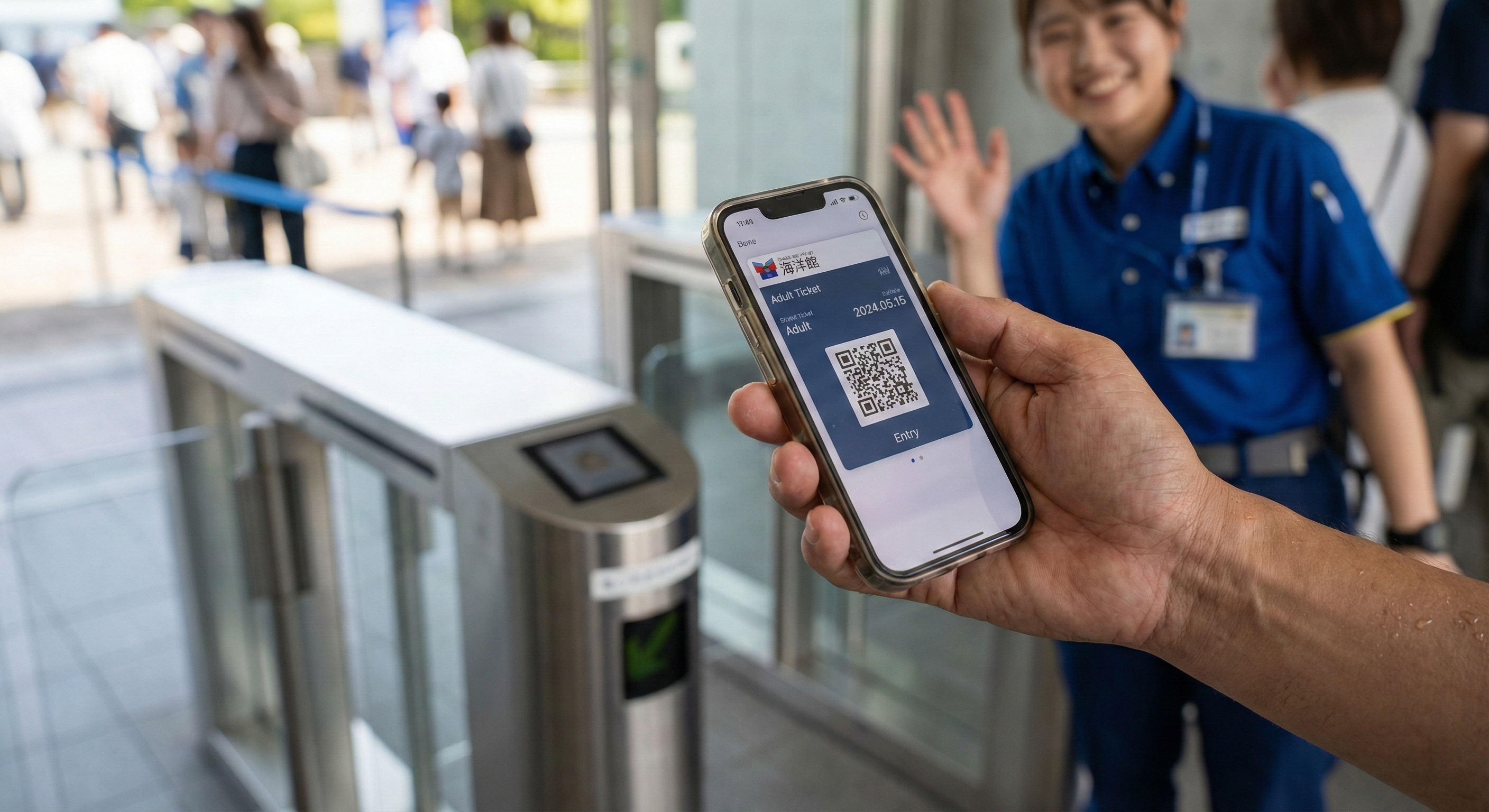 A close-up of a smartphone displaying a QR code ticket at the Osaka Aquarium digital entry gate for a quick and easy check-in. 